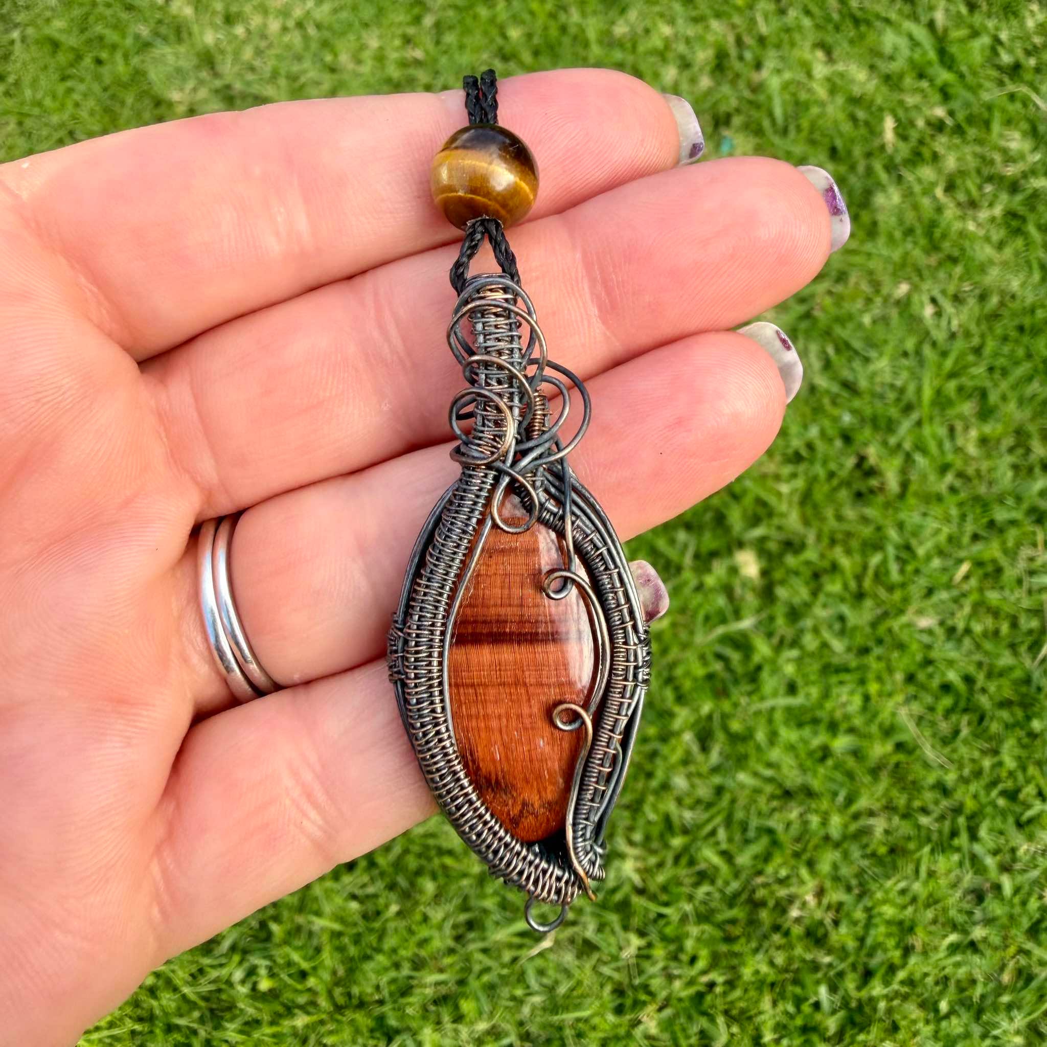 Crimson Cauldron is a handmade red and golden tiger's eye necklace from New Zealand, a Luna Magick collab piece for grounding, motivation and personal power.